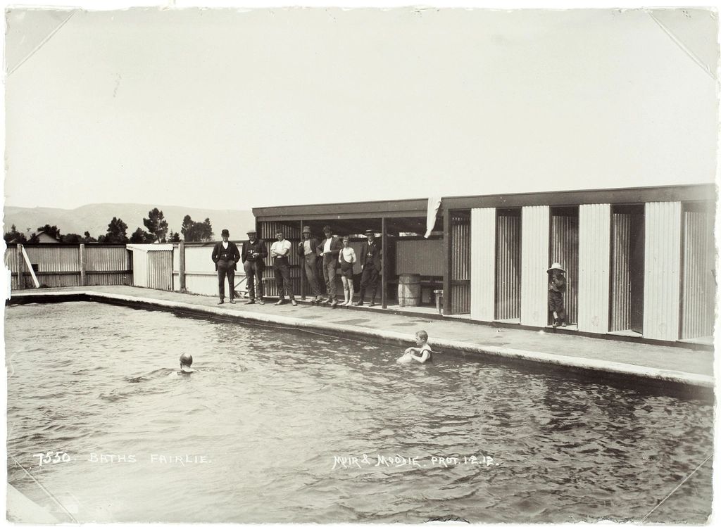 The outdoor swimming pool with loungers alongside