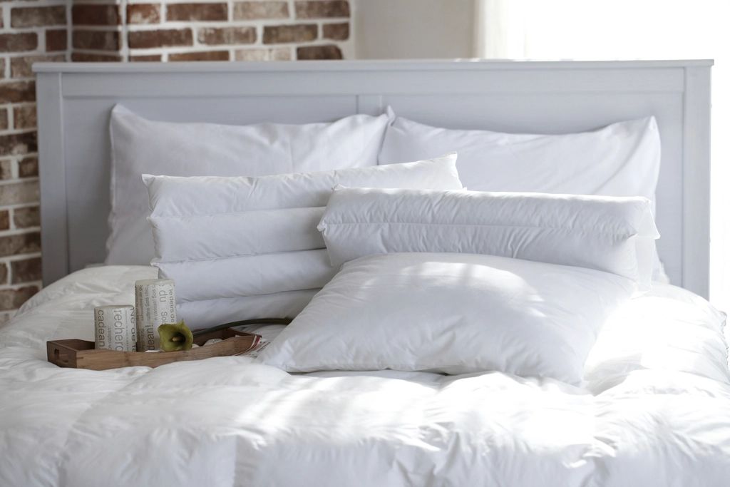 A guest room with a large bed and soft lighting